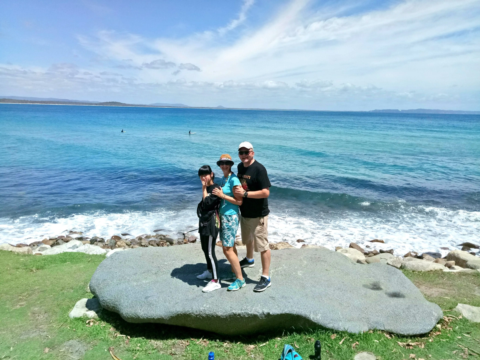 Estudante com família anfitriã em praia de Noosa